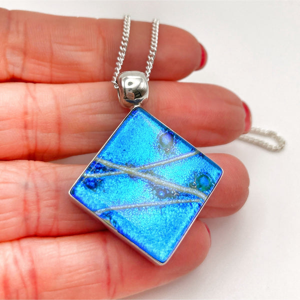 Beautiful pendant in blue and silver dichroic glass.